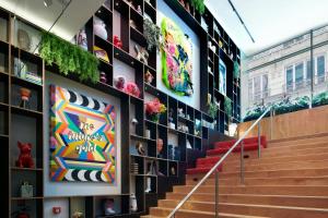a staircase in a building with a wall covered in pictures at citizenM Paris Opera in Paris