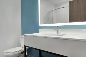a bathroom with a white sink and a mirror at StudioRes by Marriott Jackson, TN in Jackson +14 photos