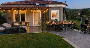 a patio with a table with fruit on it at Sountou home in Xanthi
