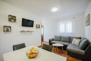 a living room with a couch and a table at Apartman Mimi - Pula airport in Pula