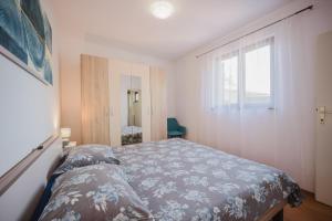 a small bedroom with a bed and a window at Apartman Mimi - Pula airport in Pula
