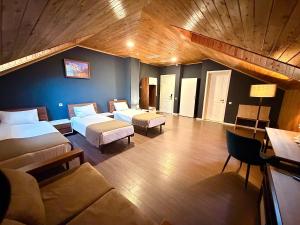 a large room with two beds and a couch at Bricks Hotel in Tbilisi City