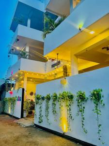 a building with plants on a white wall at Saffron Swell Villa in Arugam Bay