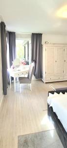 a bedroom with a desk and a table with a chair at Apartment in Flensburg