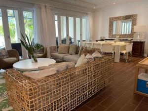 a living room with a couch and a table at Maison Cinnamon by Simply-Seychelles in Eden Island