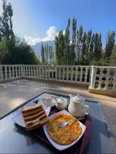 a plate of food with eggs and toast on a table at Skardu Saraye Hotel & Resort in Skardu