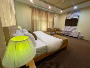 a bedroom with a large bed and a television at Skardu Saraye Hotel & Resort in Skardu