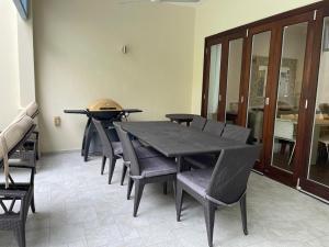 a dining room with a table and chairs at Maison Cinnamon by Simply-Seychelles in Eden Island +39 photos