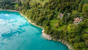 an aerial view of a house on the shore of a river at Al Trovante - Gardaslowemotion in Tenno