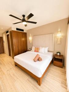 a bedroom with a large bed with a ceiling fan at Tuk Hacienda Studio Rooftop Pool Padel TUK in Tulum +24 photos