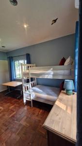 a bedroom with two bunk beds and a table at Franschhoek farm off the grid in Franschhoek