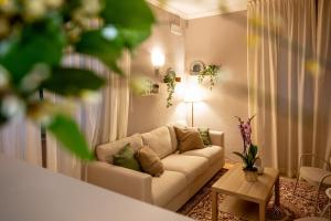 a living room with a white couch and a table at Hotel Laurin in Lido di Camaiore