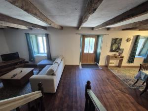 a living room with a couch and a table at Les Gites Audrain in Plussulien