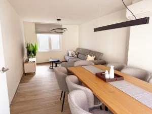 a living room with a table and a couch at Vakantiewoning Goed Thuis in Dilsen-Stokkem