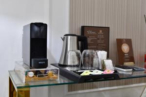a glass counter top with a coffee maker on it at Domus De Cinti Charme Rooms in Tivoli