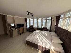 a bedroom with a bed and a living room at NEW HOTEL SAMSUN in Samsun