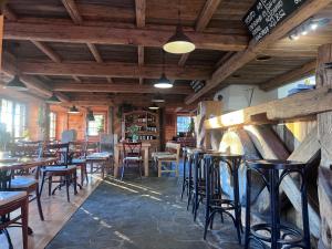 a restaurant with wooden ceilings and tables and chairs at Berry in Klatovy
