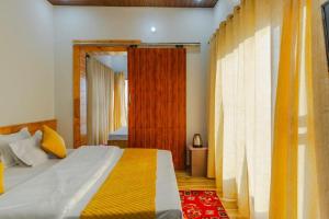 a bedroom with a bed and a wooden door at Baatuli Homestay in Nainital