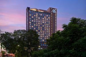 a tall building with a clock on top of it at Sheraton Kota Kinabalu in Kota Kinabalu