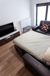 a bedroom with a bed and a flat screen tv at Laurina's Cove in Ostend