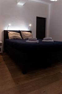 a bedroom with a bed with two pillows on it at Laurina's Cove in Ostend