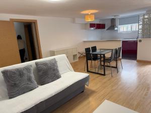 a living room with a white couch and a table at Villa del Mar in Torremolinos