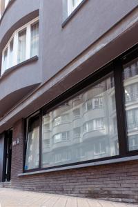 a window of a building with a reflection of a building at Laurina's Cove in Ostend