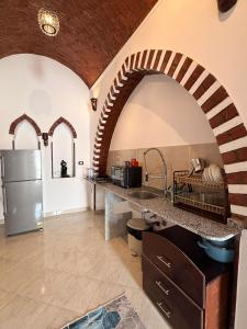 a kitchen with a counter and a refrigerator in a room at Oriental house in Luxor