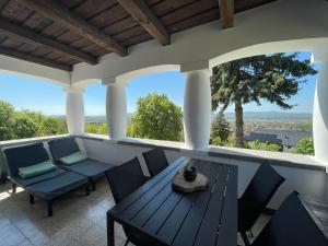 a patio with a table and chairs on a porch at Tér Pince in Sümeg +14 photos