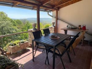 a table and chairs on a patio with a view at Tér Pince in Sümeg