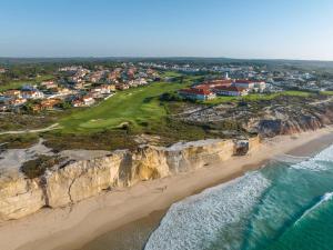 an aerial view of a golf course on a cliff next to the ocean at Wellnesshouse in Atouguia da Baleia