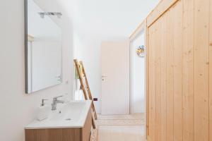 a bathroom with a sink and a mirror at Corina Secret Rooms in Martano
