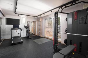 a room with a gym with a treadmill and a tv at Hotel Galija in Pula