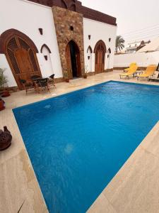 a swimming pool in front of a house at Oriental house in Luxor