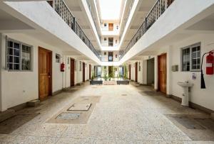 an empty hallway of an old building with a large ceiling at Miriam Inn, Chaka in Nyeri