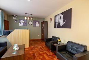 a living room with a couch and a table at Miriam Inn, Chaka in Nyeri +11 photos