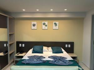 a bedroom with a bed with two towels on it at Flat Premium Sea View - Tabatinga Beach in Conde
