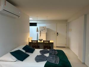 a bedroom with a white bed with bows on it at Flat Premium Sea View - Tabatinga Beach in Conde +36 photos