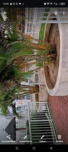 an aerial view of a building with palm trees at Âncora Horto da barra in Barra dos Coqueiros
