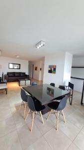a dining table and chairs in a living room at Carilo - semipiso 3 ambientes 1ºpiso in Carilo +7 photos