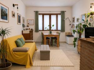 a living room with a couch and a table at La Casetta - Home Gallery in San Fiorano