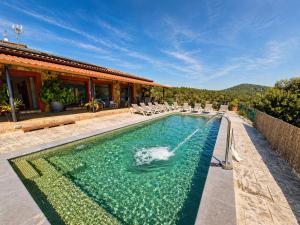 a swimming pool with a fountain in front of a house at Bravaholidays-625-Silence in Terra Brava