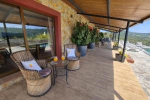 a patio with chairs and tables on a building at Bravaholidays-625-Silence in Terra Brava