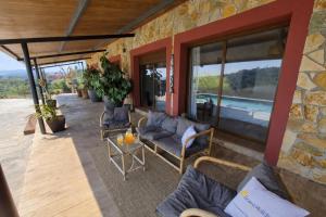 a patio with a couch and chairs on a building at Bravaholidays-625-Silence in Terra Brava +37 photos