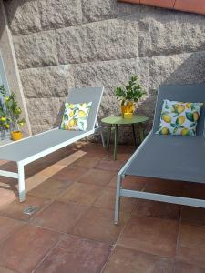 two chairs and a table on a patio at Stone House Premium Room in Porriño