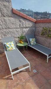 two benches and a table on a patio at Stone House Premium Room in Porriño