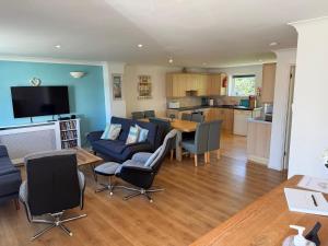 a living room with a couch and a table at Seashells in Newquay