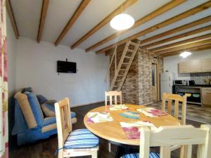 a living room with a table and a blue couch at Agroturystyka Kozianka in Iława