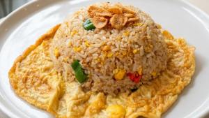a white plate of food with rice and vegetables at Labore Homestay in Waha +18 photos