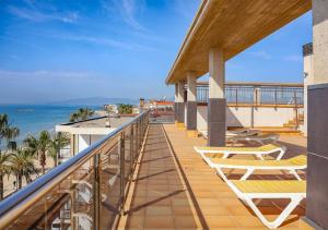 a balcony with chairs and a view of the ocean at Apartamentos las Palmas VII Family only in Salou